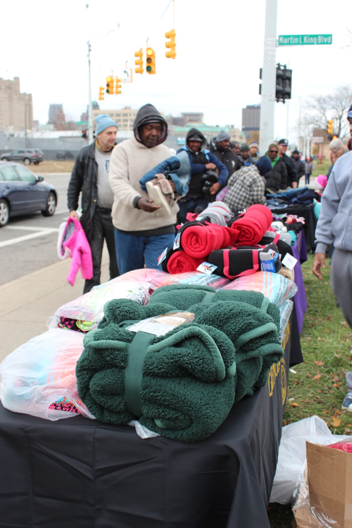 Expanded distribution table with blankets, hats, and gloves