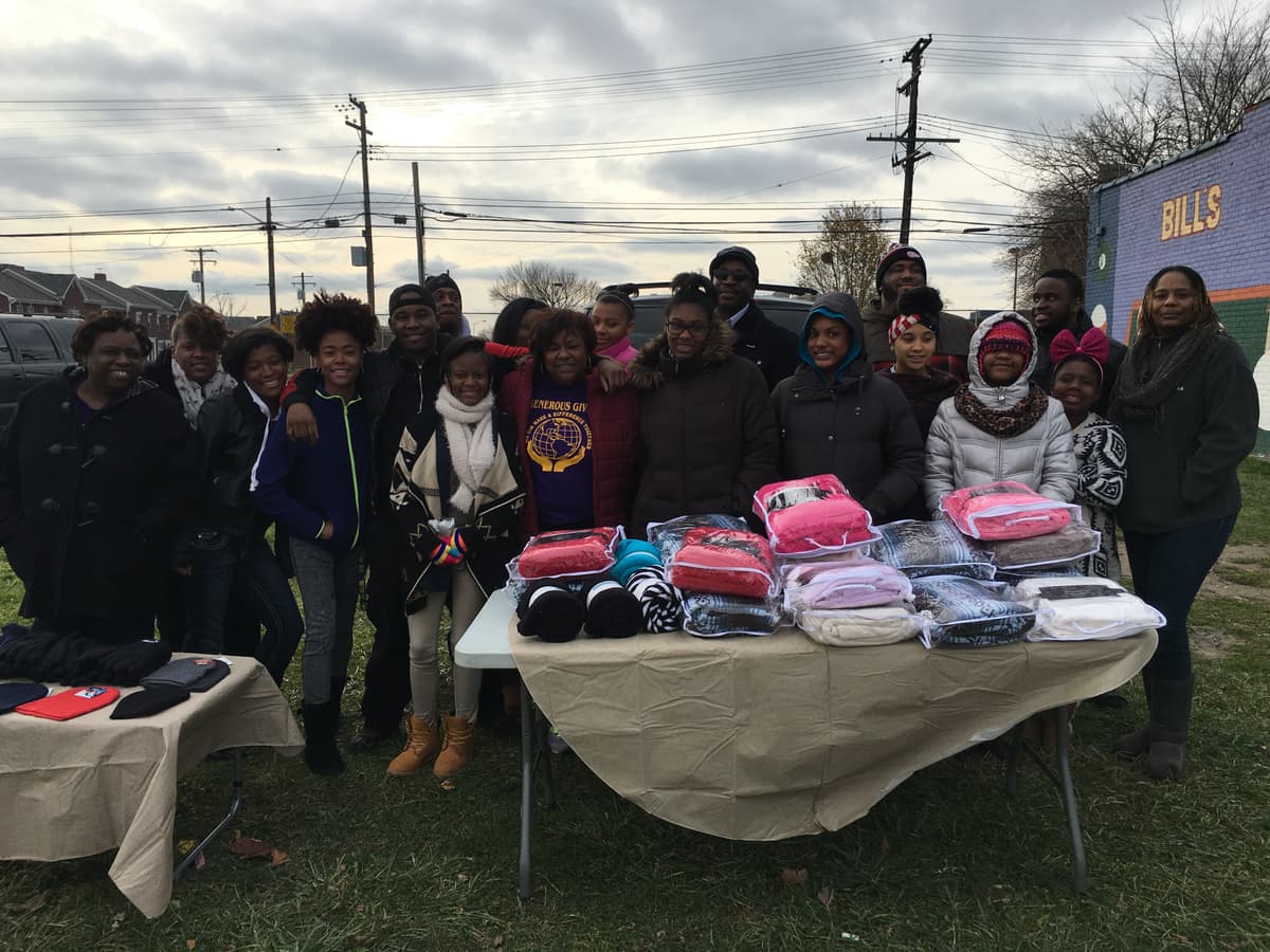 Generous Giving team with a full table of blankets and supplies