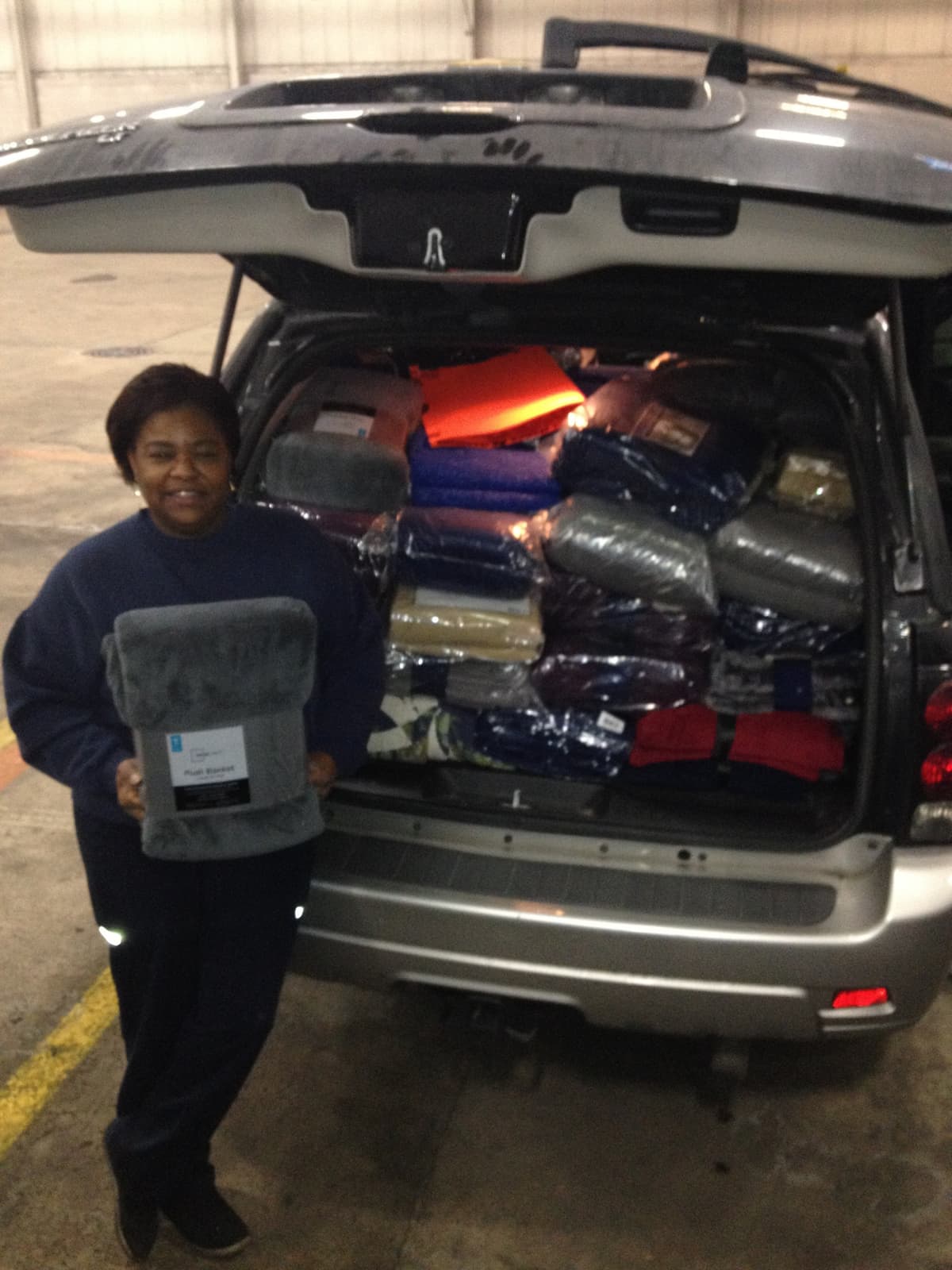 Karen loading her car full of blankets for distribution