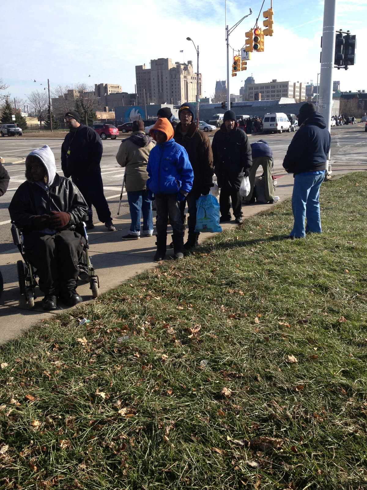 Community members with blankets — Detroit skyline