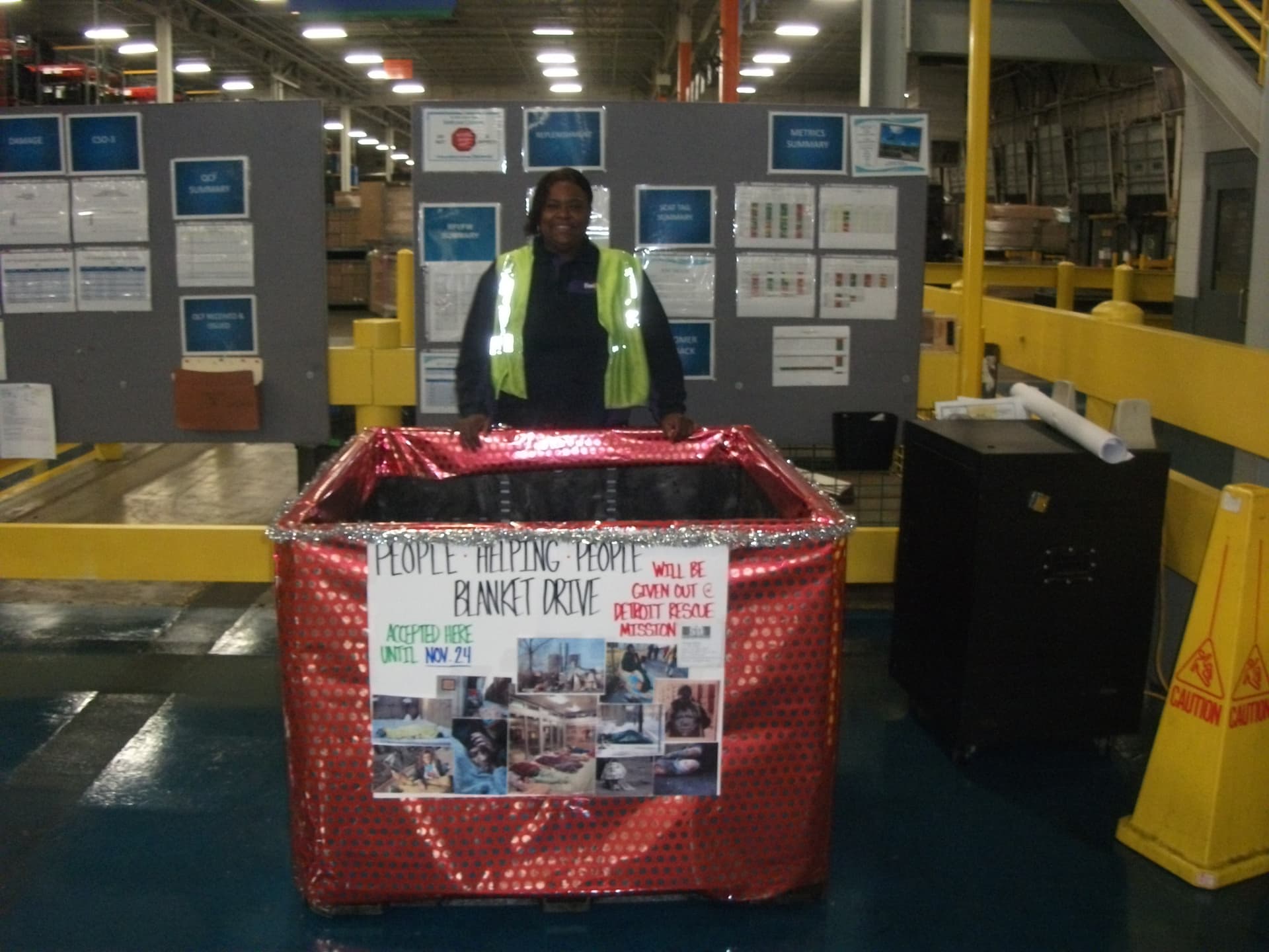 Karen at GM/FedEx with People Helping People blanket drive bin — 2012