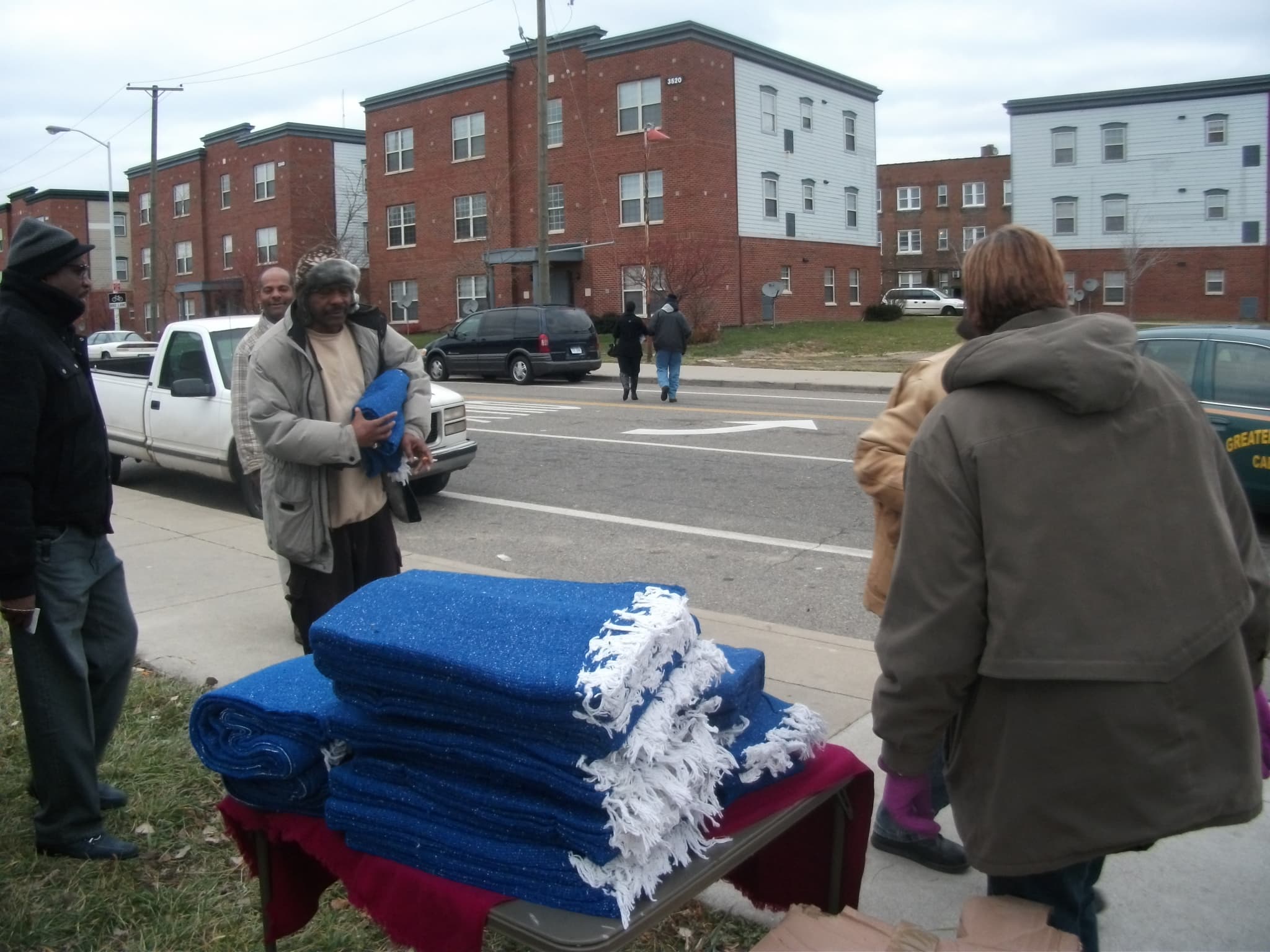 Blankets stacked on table for community distribution
