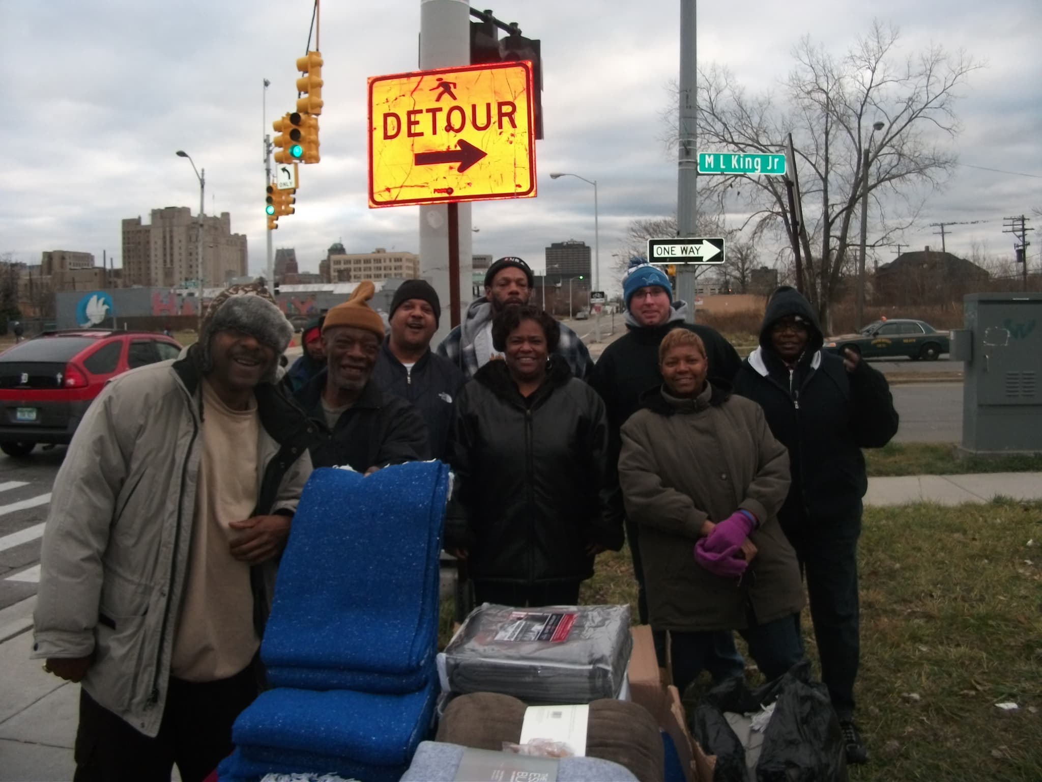 Generous Giving founders at MLK and 3rd Street with the street sign visible